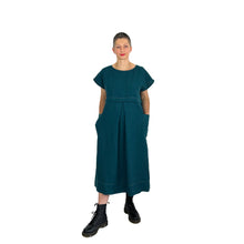 Load image into Gallery viewer, Martha dress pattern view A sleeveless in teal linen fabric on model - hands in pockets, front view