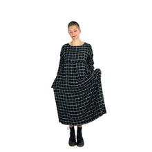 Load image into Gallery viewer, Martha dress pattern view B on model in black and white grid viscose fabric - tapered sleeves, three shallow inverted pleats on skirt, front view, hands in pockets