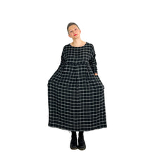 Load image into Gallery viewer, Martha dress pattern view B on model in black and white grid viscose fabric - tapered sleeves, three shallow inverted pleats on skirt, front view, hands in pockets