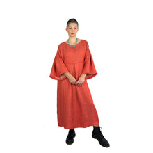 Load image into Gallery viewer, Martha dress pattern view A on model in heavyweight coral linen - wide sleeves, deep pleats, full front view