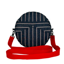 Load image into Gallery viewer, minnie bag sewing pattern by dhurata davies, round bag with red strap, made in denim fabric with white and red stripes, stripes positioned in different directions to highlights the pocket shapes