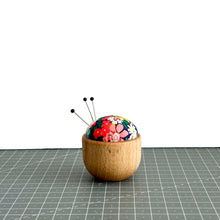 Load image into Gallery viewer, a handmade pincushion in liberty fabric on a wooden base, three pins on it, cute floral fabric, thorpe