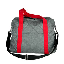 Load image into Gallery viewer, rome weekender - travel bag sewing pattern by dhurata davies, made in a quilted grey fabric with red handles and black shoulder strap. front view showing front pocket, handles and shoulder strap