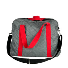 Load image into Gallery viewer, rome weekender - travel bag sewing pattern by dhurata davies, made in a quilted grey fabric with red handles and black shoulder strap. front view showing front pocket, handles and shoulder strap