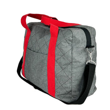 Load image into Gallery viewer, rome weekender - travel bag sewing pattern by dhurata davies, made in a quilted grey fabric with red handles and black shoulder strap. side view showing zipper, front pocket, handles and shoulder strap