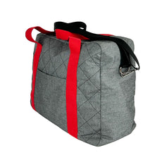 Load image into Gallery viewer, rome weekender - travel bag sewing pattern by dhurata davies, made in a quilted grey fabric with red handles and black shoulder strap. side view showing the depth, front pocket, handles and shoulder strap