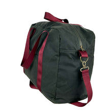 Load image into Gallery viewer, rome weekender - travel bag sewing pattern by dhurata davies, made in a dark taupe waxed cotton fabric with burgundy webbing. side view showing zipper, front pocket, handles and shoulder strap