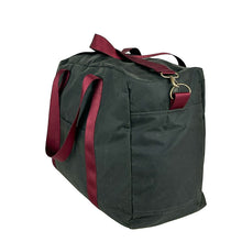 Load image into Gallery viewer, rome weekender - travel bag sewing pattern by dhurata davies, made in a dark taupe waxed cotton fabric with burgundy webbing. side view showing the depth, front pocket, handles and shoulder strap