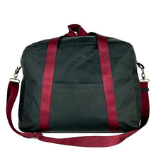 Load image into Gallery viewer, rome weekender - travel bag sewing pattern by dhurata davies, made in a dark taupe waxed cotton fabric with burgundy webbing. front view showing front pocket, handles and shoulder strap