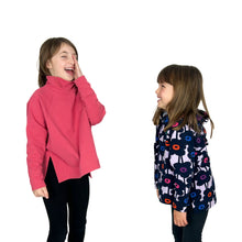 Load image into Gallery viewer, Side view of Wren Pullover sewing pattern by Dhurata Davies. Child models wearing View A hoodie and View B high neck pullover, laughing together.