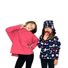 Load image into Gallery viewer, Front view of Wren Pullover sewing pattern by Dhurata Davies. Child model on right wearing View A hoodie with hood up, biting into an apple. Child model on left wearing View B high neck pullover in pink.