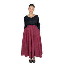 Load image into Gallery viewer, Ziggy Skirt sewing pattern by Dhurata Davies, front view with model’s hands in pockets, made in cerise and burgundy striped poplin fabric