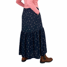 Load image into Gallery viewer, Olive Skirt sewing pattern, View A — back view of long skirt with hands in side seam pockets, black fabric with tan spots
