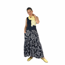 Load image into Gallery viewer, Olive Skirt sewing pattern, View C — front view with one hand in front slanted pocket, black and white palm leaf fabric
