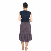 Load image into Gallery viewer, Olive skirt sewing pattern, View D — back view of mid-length skirt with integrated front pockets, made in dark plum fabric with tiny white polka dots