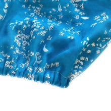 Load image into Gallery viewer, penny romper sewing pattern for babies and toddlers, by dhurata davies,  detail view of the elasticated romper leg made in a blue and white floral fabric