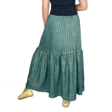 Load image into Gallery viewer, Olive skirt sewing pattern, View C — back view of long tiered skirt with curved high-low hem, made in stripy teal fabric with stripe direction variation between skirt and bottom ruffle
