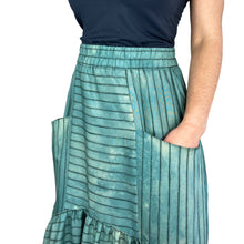 Load image into Gallery viewer, Olive skirt sewing pattern, View C — close-up of integrated front pocket with hand inside, showing elasticated waistband