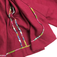 Load image into Gallery viewer, The Overlap sewing pattern by dhurata davies, showing the inner detail of the hong kong bound facing on the burgundy short version of the jacket
