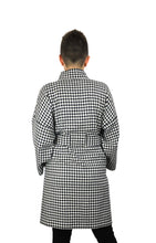 Load image into Gallery viewer, The Overlap sewing pattern by dhurata davies, back view of the black and white long version, hands in front pockets