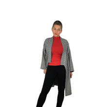 Load image into Gallery viewer, The Overlap sewing pattern by dhurata davies, front open view of the black and white long version, worn with a red top underneath and black skinny jeans