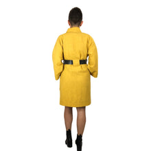 Load image into Gallery viewer, The Overlap sewing pattern by dhurata davies, back view of the yellow long version, worn with a leather belt, with both hands inside the front patch pockets