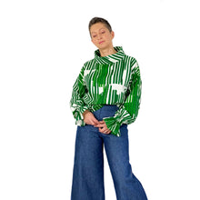 Load image into Gallery viewer, Edith - dress, skirt and top sewing pattern, top with elasticated cuffs and funnel neck, green and white double gauze fabric, front view, styled with wide-leg jeans