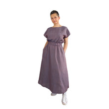 Load image into Gallery viewer, Edith sewing pattern – long sleeveless linen dress with elasticated waist and curved hem, slight left side turn, styled casually with white trainers