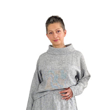 Load image into Gallery viewer, Edith sewing pattern – skirt and top co-ord in black and white tiny check linen, top with funnel neck and tapered long sleeves, partially tucked, left hand on skirt waistband