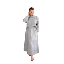 Load image into Gallery viewer, Edith sewing pattern – skirt and top co-ord in black and white tiny check linen, top tucked in at front centre, right hand touching back of head, left hand in pocket