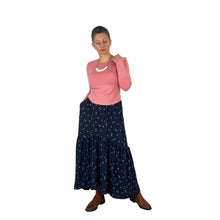 Load image into Gallery viewer, Olive Skirt sewing pattern, View A — long skirt with side seam pockets, front view, made in black fabric with tan spots