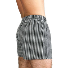 Load image into Gallery viewer, Man wearing the Hugo Boxers sewing pattern in black and white gingham, angled side view