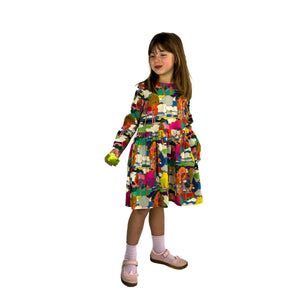 finished may pattern in liberty tana lawn fabric, little model turned slightly to her left, looking right, half eaten apple in hand