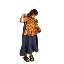 Load image into Gallery viewer, finished May dress on model, elegant view A in grey linen, model holding a finished May tp, view C, in cotton gingham 