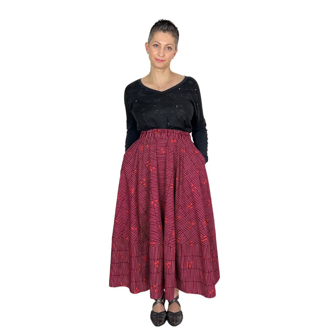 ziggy skirt sewing pattern by dhurata davies, front view with hands in pockets, cerise/burgundy poplin fabric