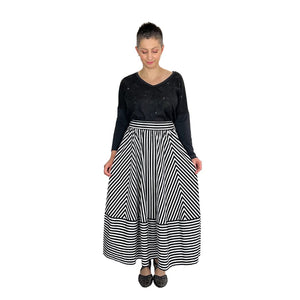 ziggy skirt sewing pattern by dhurata davies, striped black and white fabric, looking down, holding skirt at sides